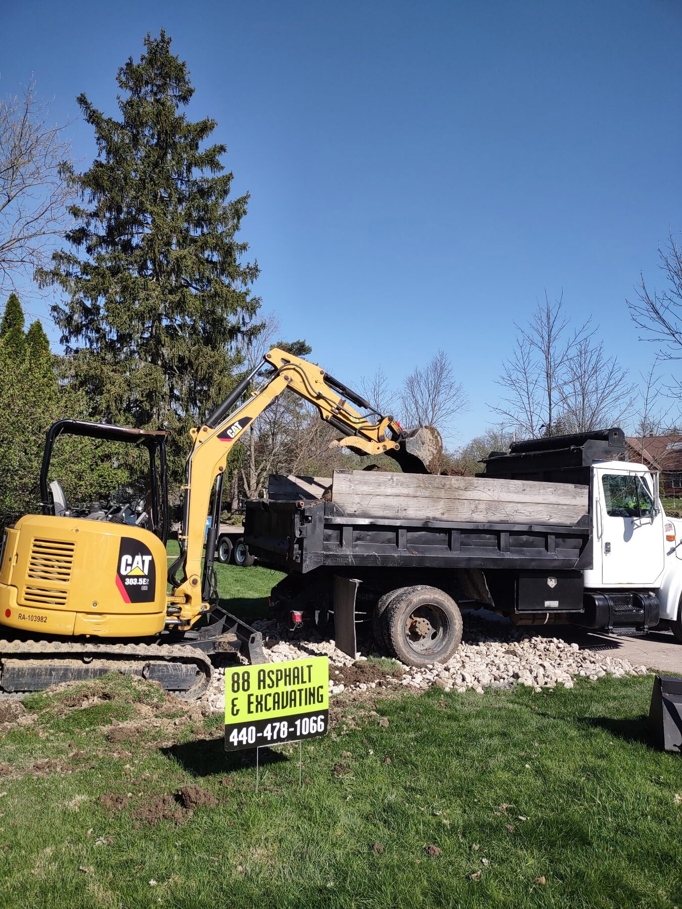 CAT excavator and dump truck on an 88 Asphalt job site