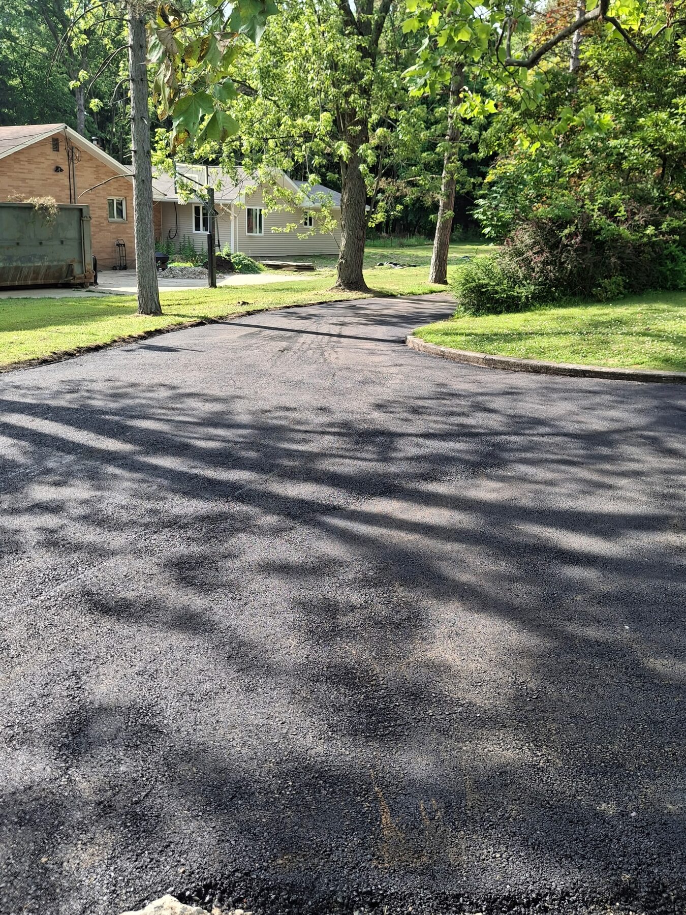 Freshly paved residential asphalt driveway